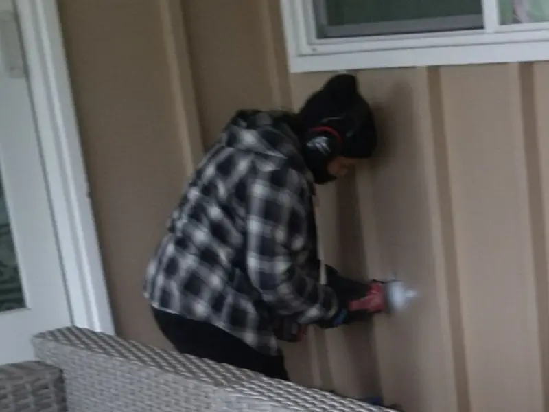 Professional electrician installing an exterior outlet in Forward